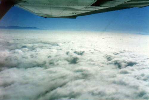 Impressive sight of the plane on top of  a dense layer of cloud covering the sea between Santa Catalina and LA.