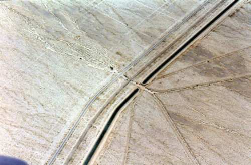 A  picture of the strange abstract pattern traced in the desert by a road, a river and railway tracks.