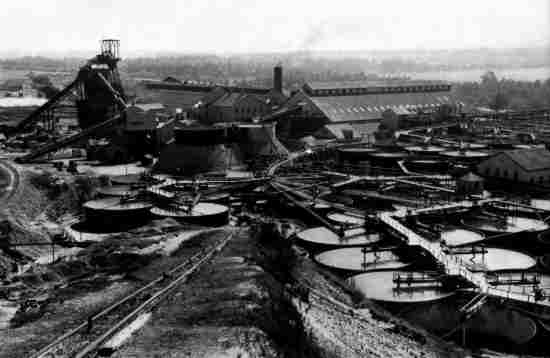 Industrial mining landscape with huge cyanide tanks